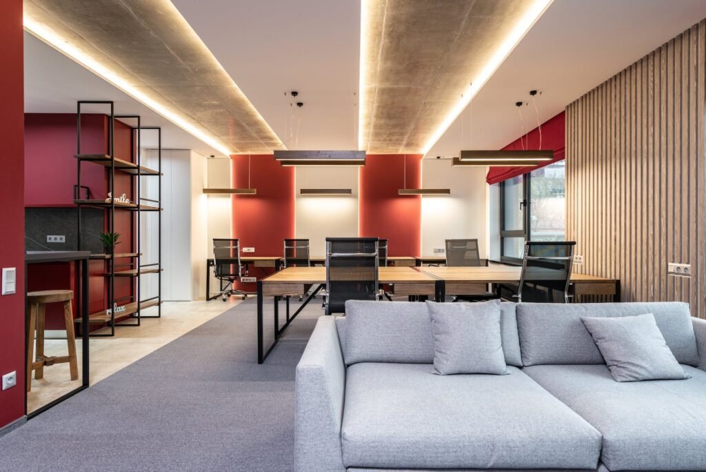 lounge zone in office with couch near tables with chairs
